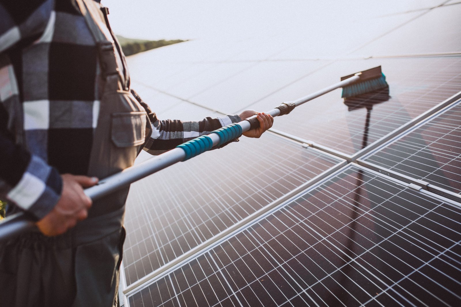 man worker firld by solar panels scaled